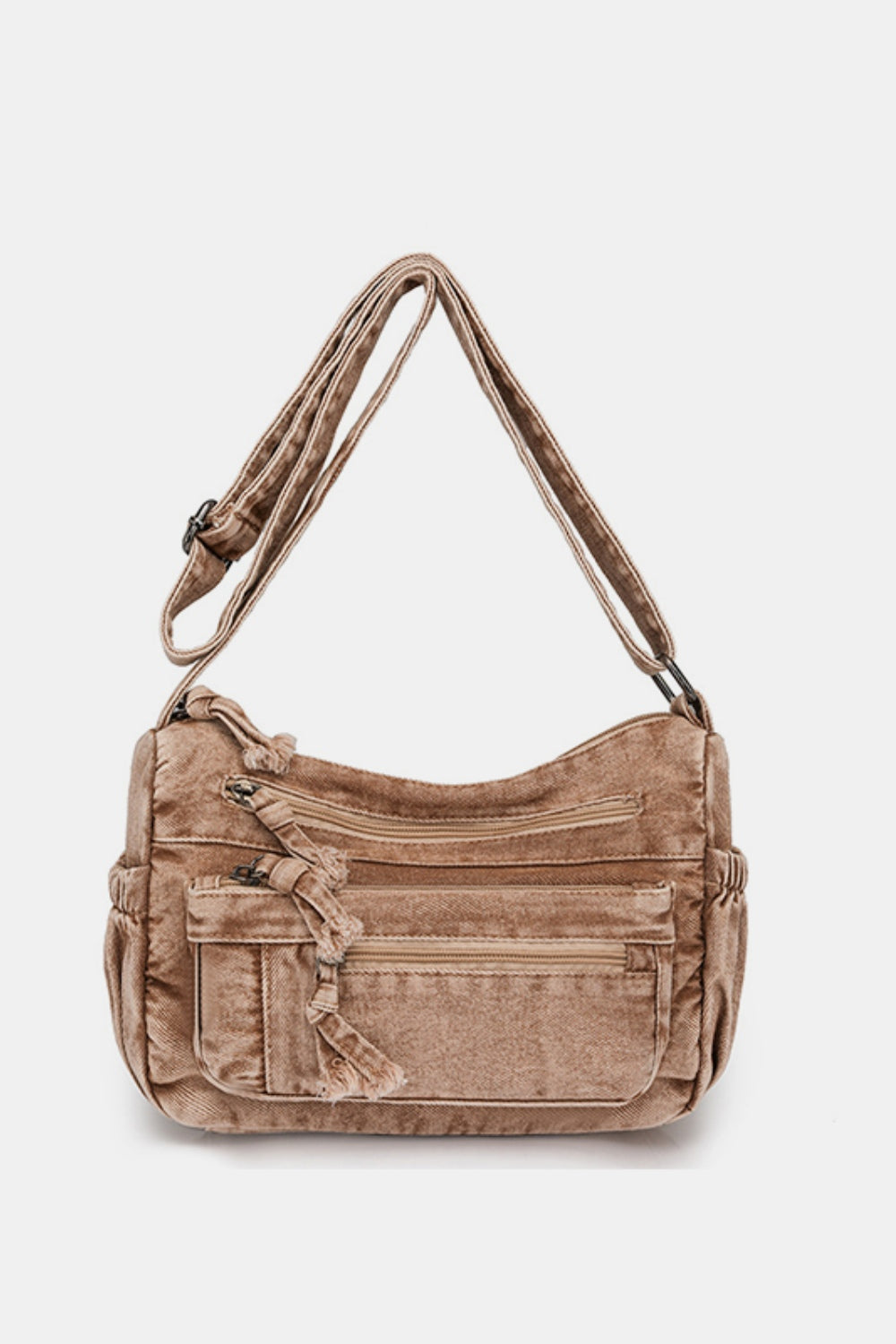 Taupe denim crossbody bag with an adjustable strap, softly curved top line, medium rectangular silhouette, and multiple zippered front pockets.