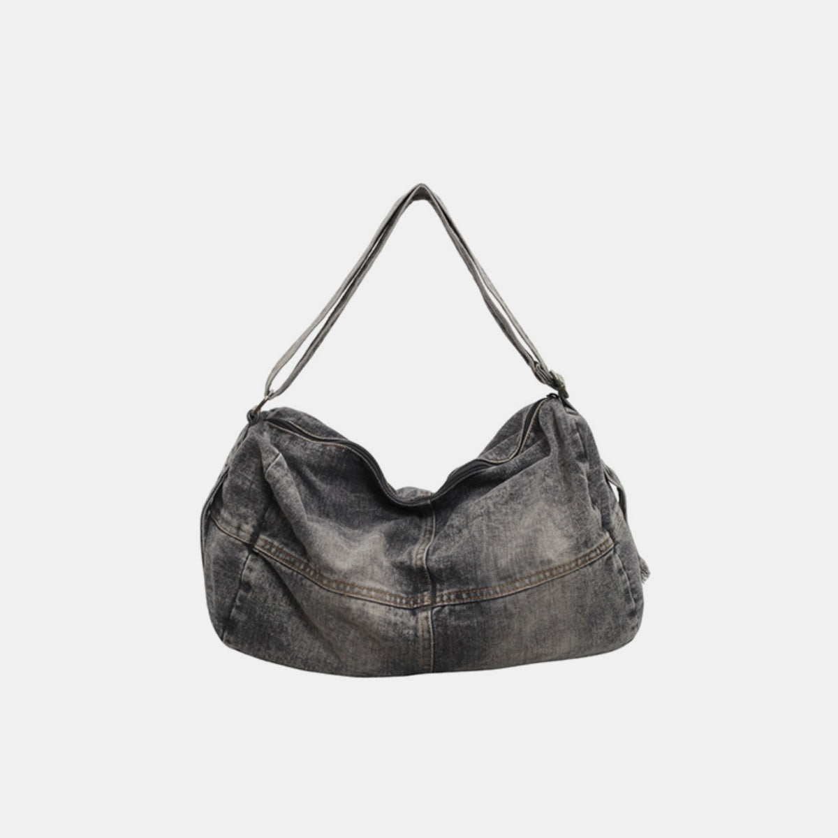 Large washed-gray denim tote bag with a softly curved, slouchy silhouette, visible seam detailing, and an adjustable shoulder strap.