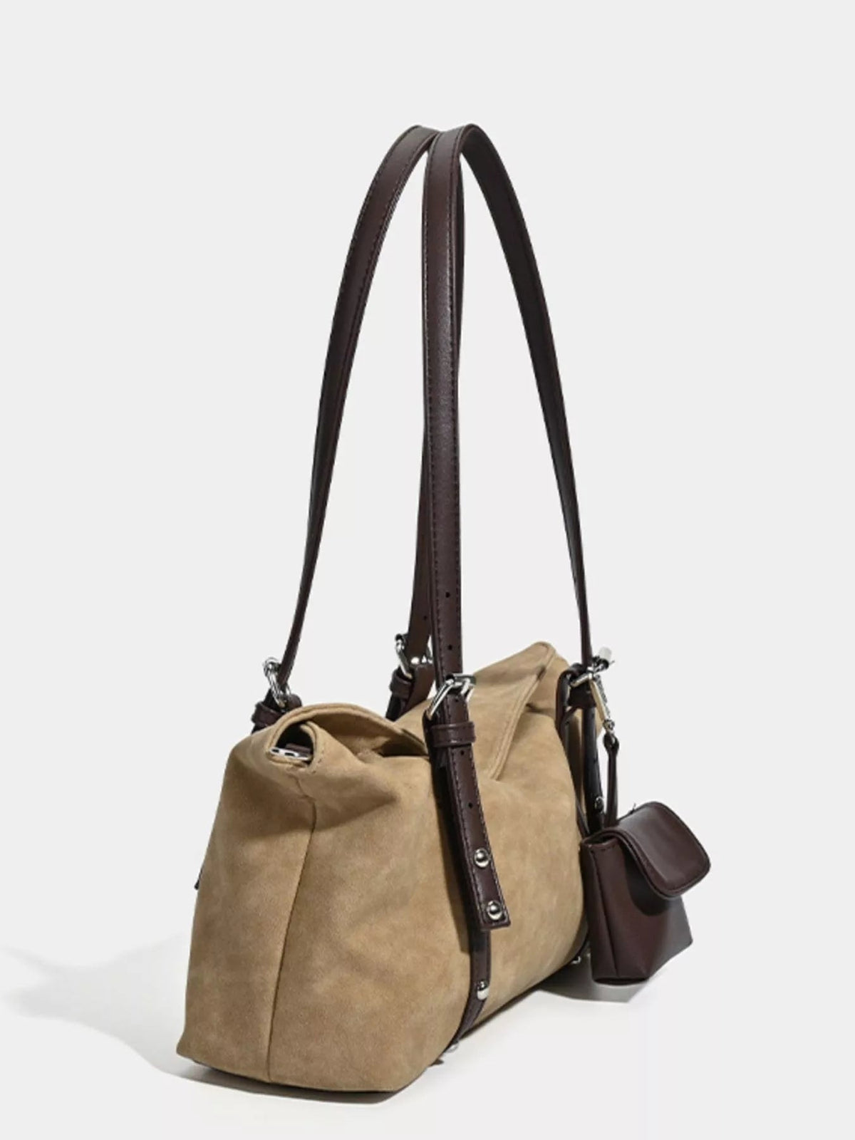 Medium tan suede shoulder bag with a relaxed silhouette, adjustable dark brown leather straps, reinforced trim, metal hardware, and an attached side pouch.