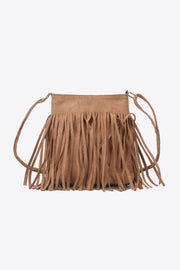 Small tan PU leather crossbody sling bag with a compact rectangular silhouette, long layered fringe, and a slim adjustable strap.