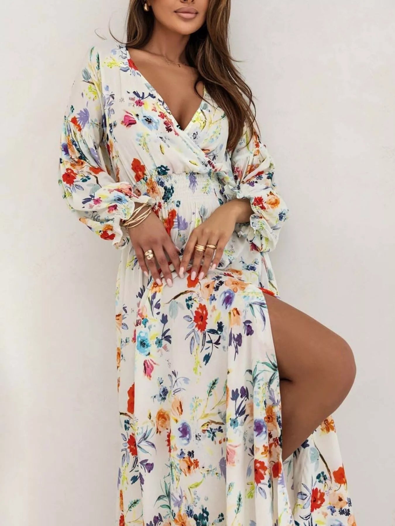 Bohemian floral printed maxi dress with plunging neckline, ruched waist, tiered skirt, and long flowy sleeves