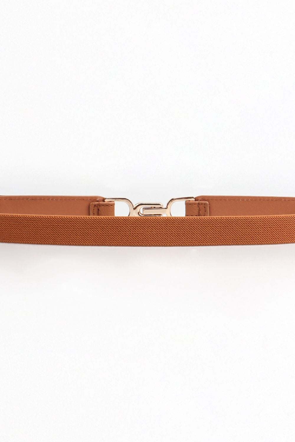 Slim brown elastic belt with a textured PU finish, stitched edges, and a sculptural interlocking alloy buckle for polished waist definition.
