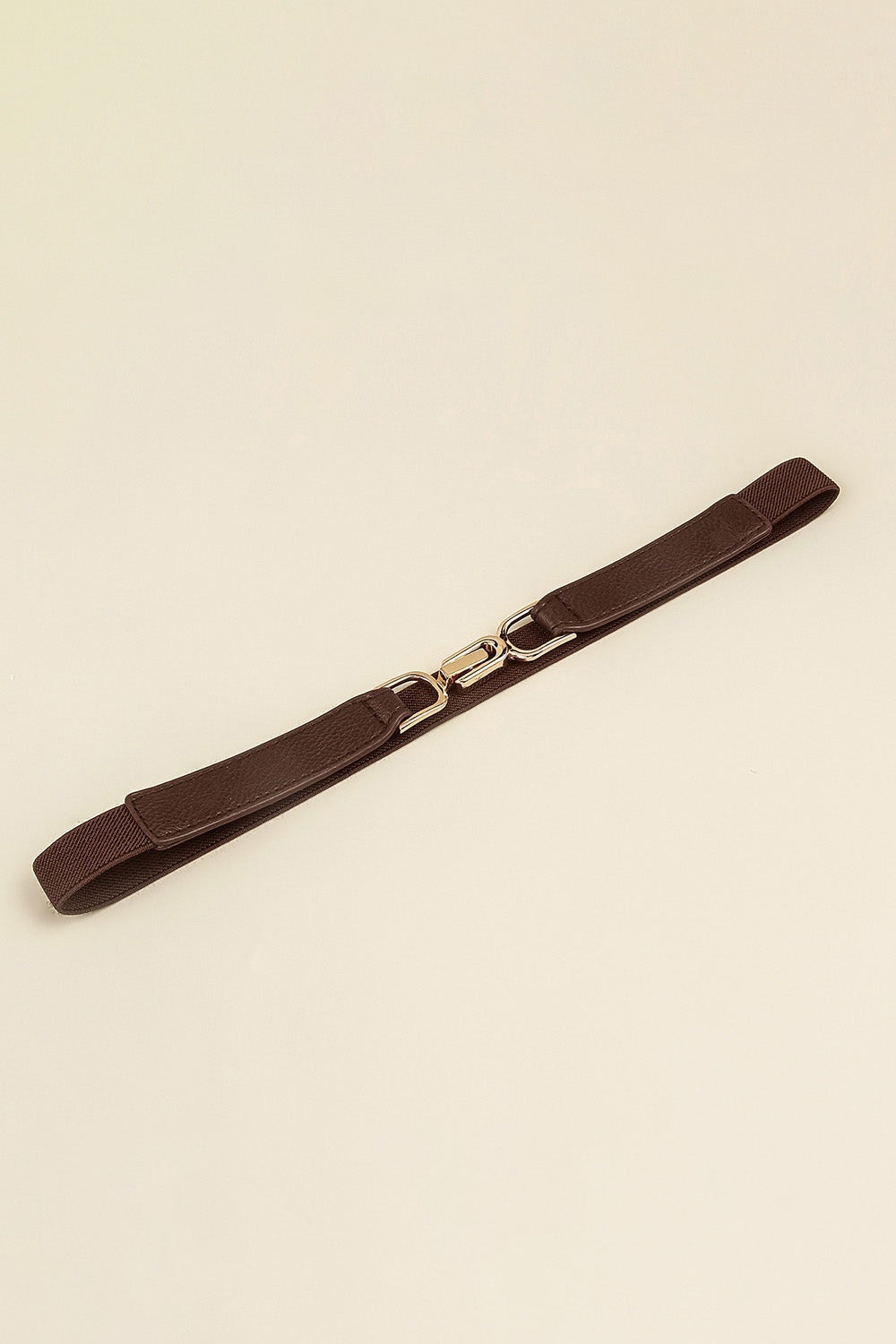 Brown slim elastic belt with textured PU panels, stitched edges, and a polished alloy interlocking buckle displayed fully extended.
