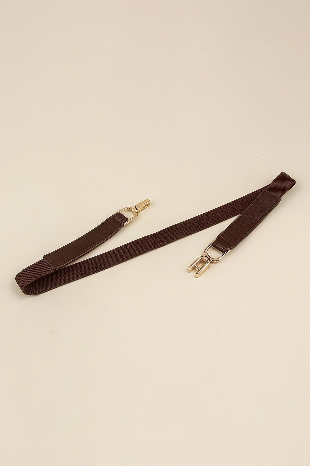 Brown slim elastic belt with textured PU panels, visible stitched edges, and gold-tone alloy buckle hardware shown laid flat in an extended silhouette.