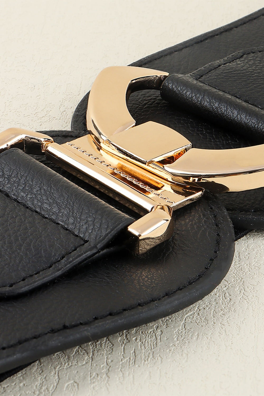 Black PU and elastic Alloy Buckle Belt with a broad structured silhouette, curved ends, and a polished gold-tone alloy buckle.