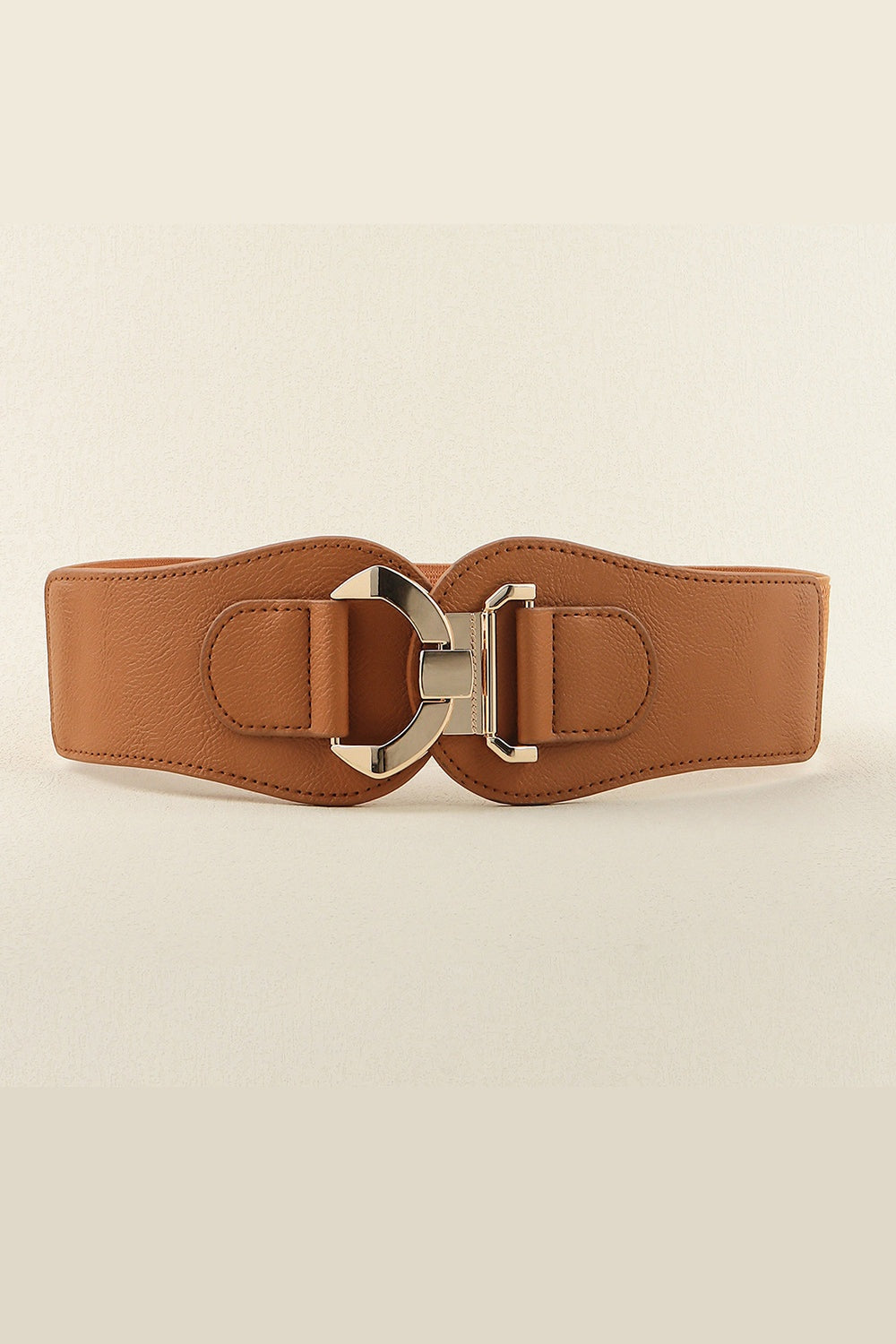 Broad brown PU and elastic belt with curved stitched edges and a sculptural alloy buckle, creating a polished, waist-defining accessory.