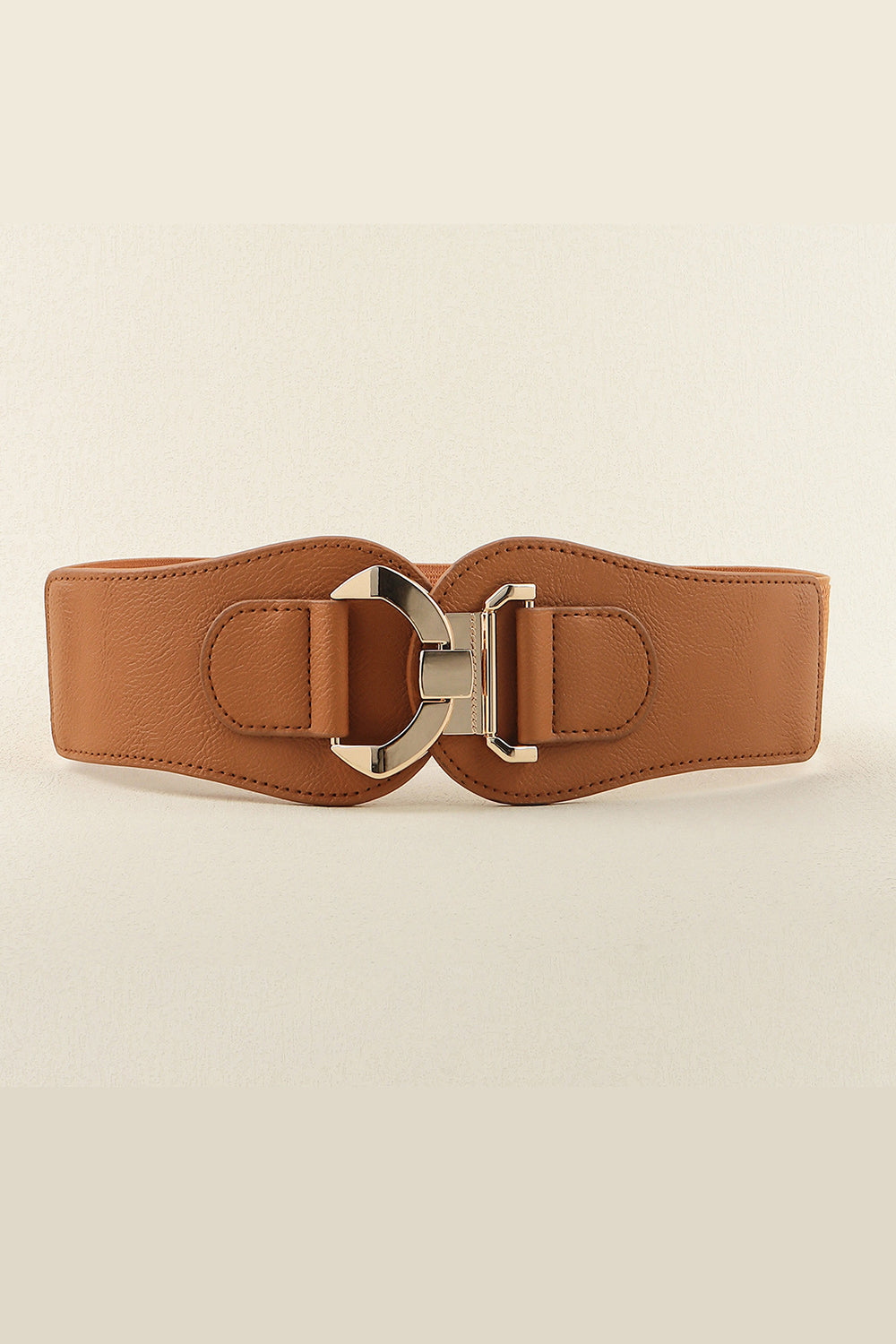 Broad brown PU and elastic belt with curved stitched edges and a sculptural alloy buckle, creating a polished, waist-defining accessory.
