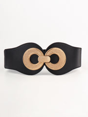 Wide black elastic PU belt with a sculptural silhouette, stitched edges, and an oversized alloy buckle featuring two interlocking textured gold-tone circles.