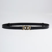 A slim black PU belt with clean edging and a distinctive alloy buckle featuring interlocking circular rings.