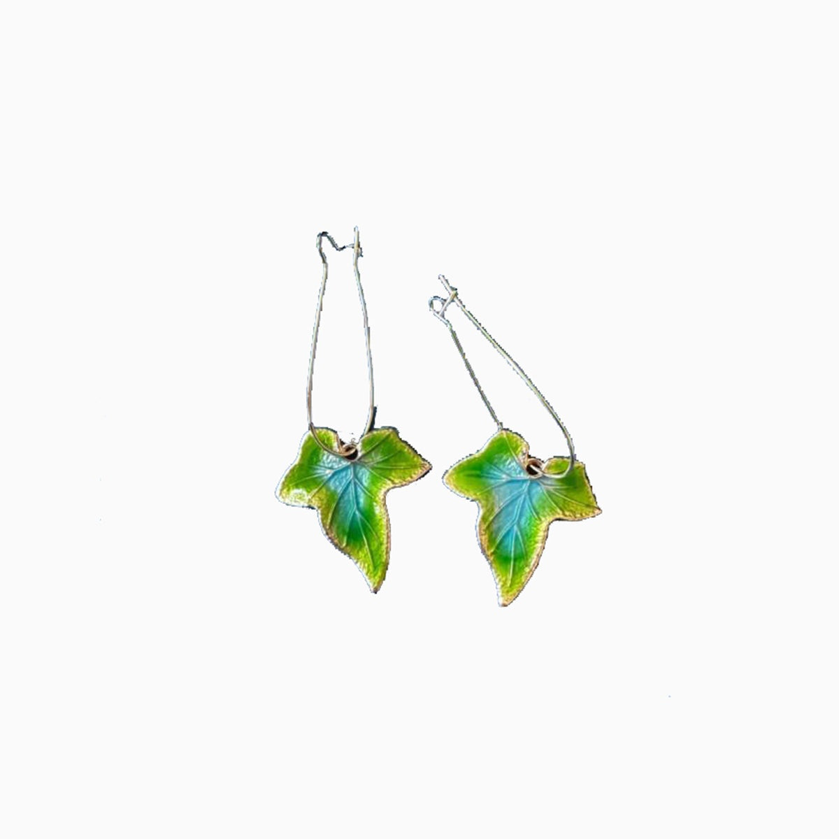 Green-and-blue alloy leaf drop earrings feature veined, elongated leaf silhouettes suspended from slender hook wires.