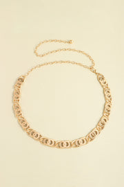 Gold-tone alloy lobster clasp belt featuring linked oval detailing, a slim chain design, and an extended chain for adjustable draping.