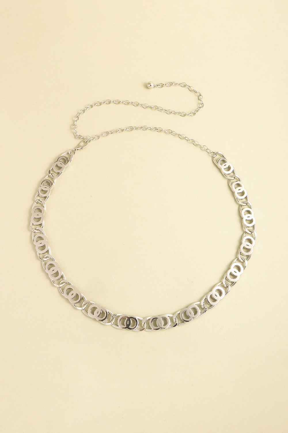 Silver-tone alloy lobster clasp belt featuring linked oval detailing, a slim chain silhouette, and an extended chain fastening for adjustable styling.