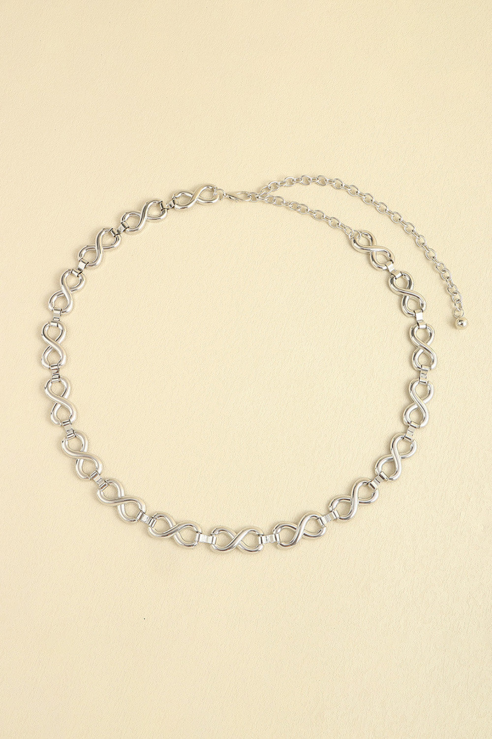Silver alloy chain belt featuring repeating linked-circle details, a delicate 0.8-inch profile, and a fine chain extension with lobster clasp.