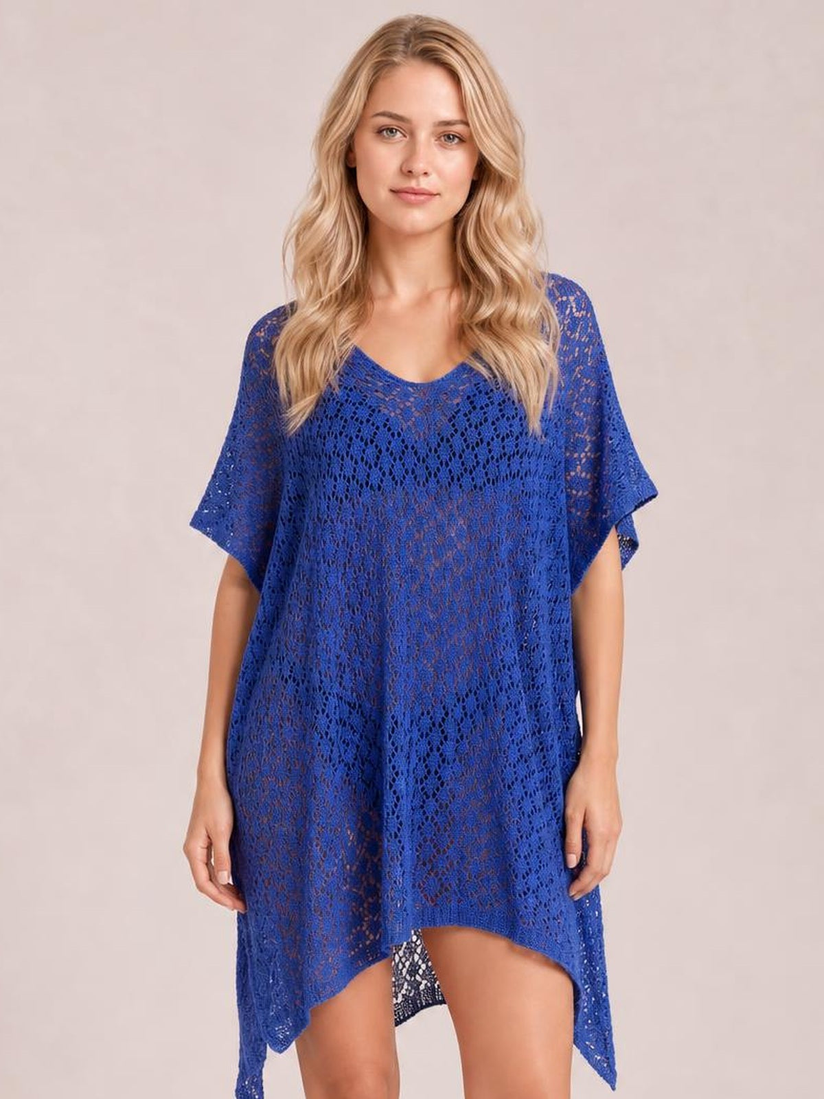 Model stands facing forward in a royal blue semi-sheer openwork cover up with a scoop neck, loose short sleeves, side slits, and a flowing high-low hem.