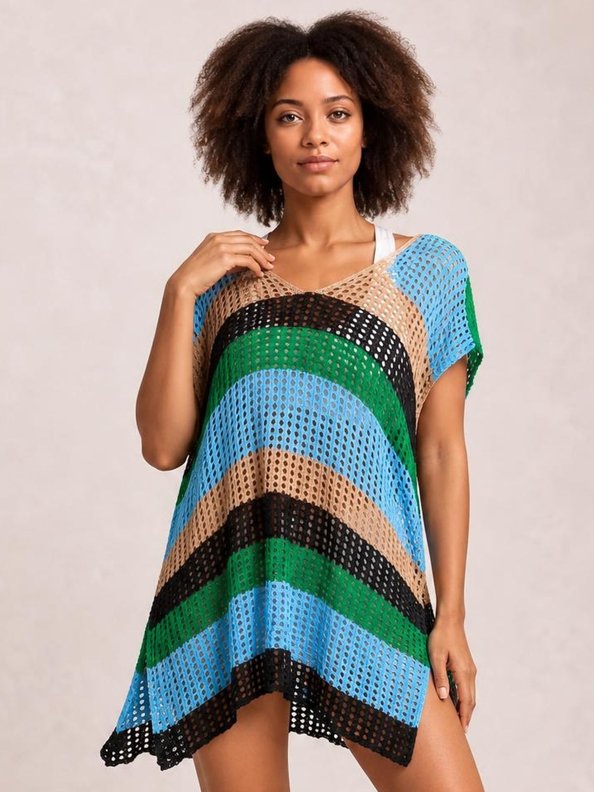 A model poses in a loose, multicolor striped V-neck cover up with short sleeves, stretchy semi-sheer openwork and a flowing tunic silhouette.