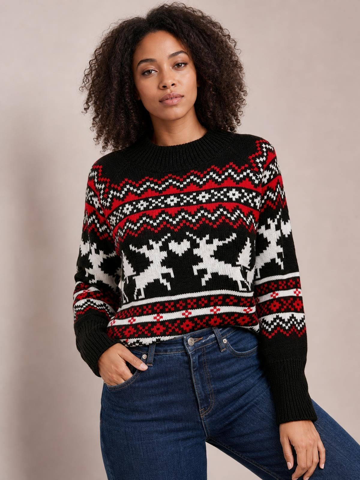 Model wears a black, red, and white reindeer sweater with a round neck, long sleeves, ribbed cuffs and hem, and a relaxed silhouette.