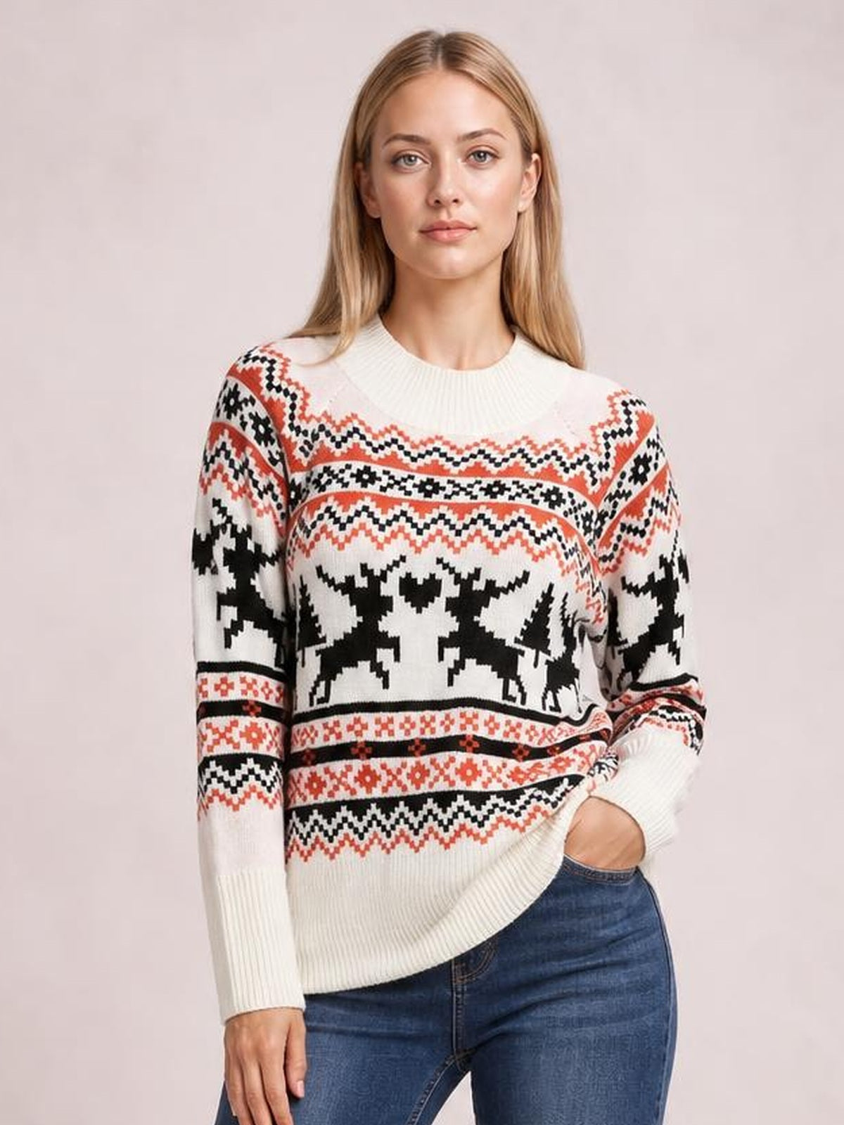 Model wearing a cream round-neck long-sleeve reindeer sweater with a relaxed silhouette, ribbed cuffs and hem, and black and red patterned knit bands.