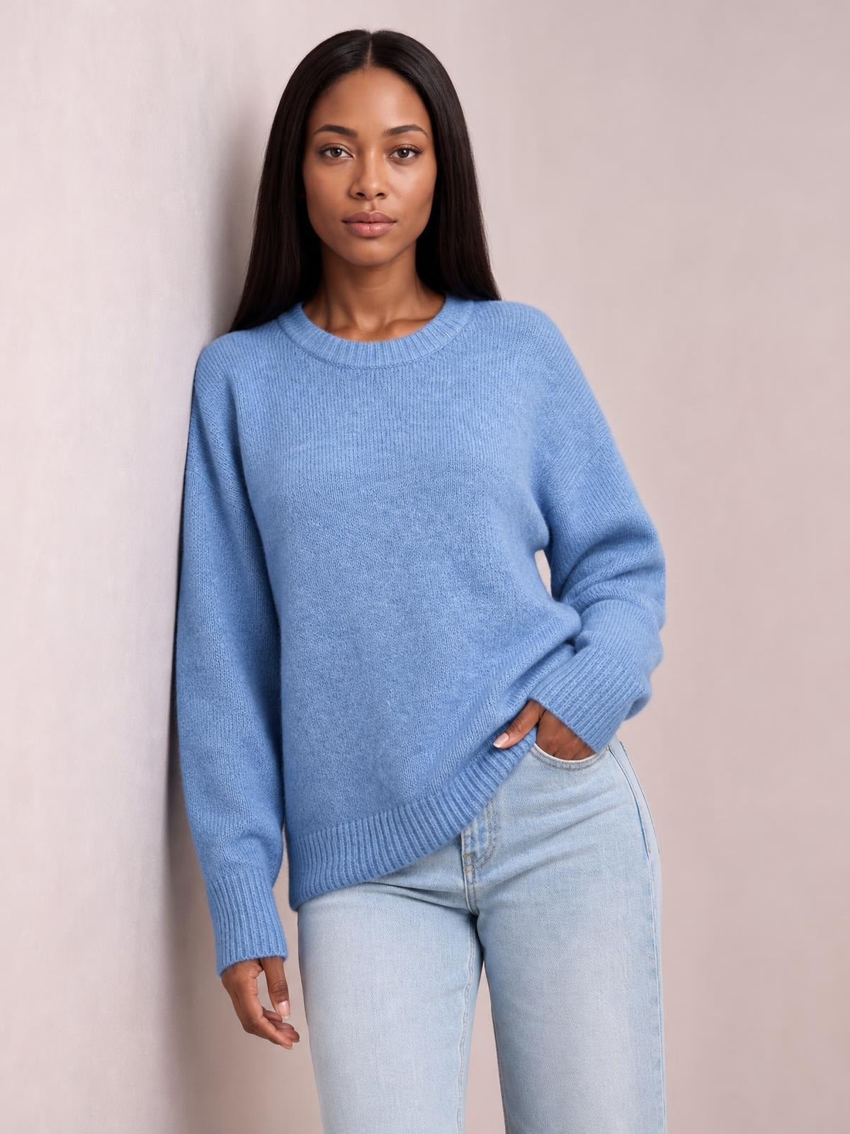 A model poses in a casual solid light blue ribbed sweater with a round neck, long regular sleeves, ribbed cuffs and hem, and a relaxed regular-length silhouette.
