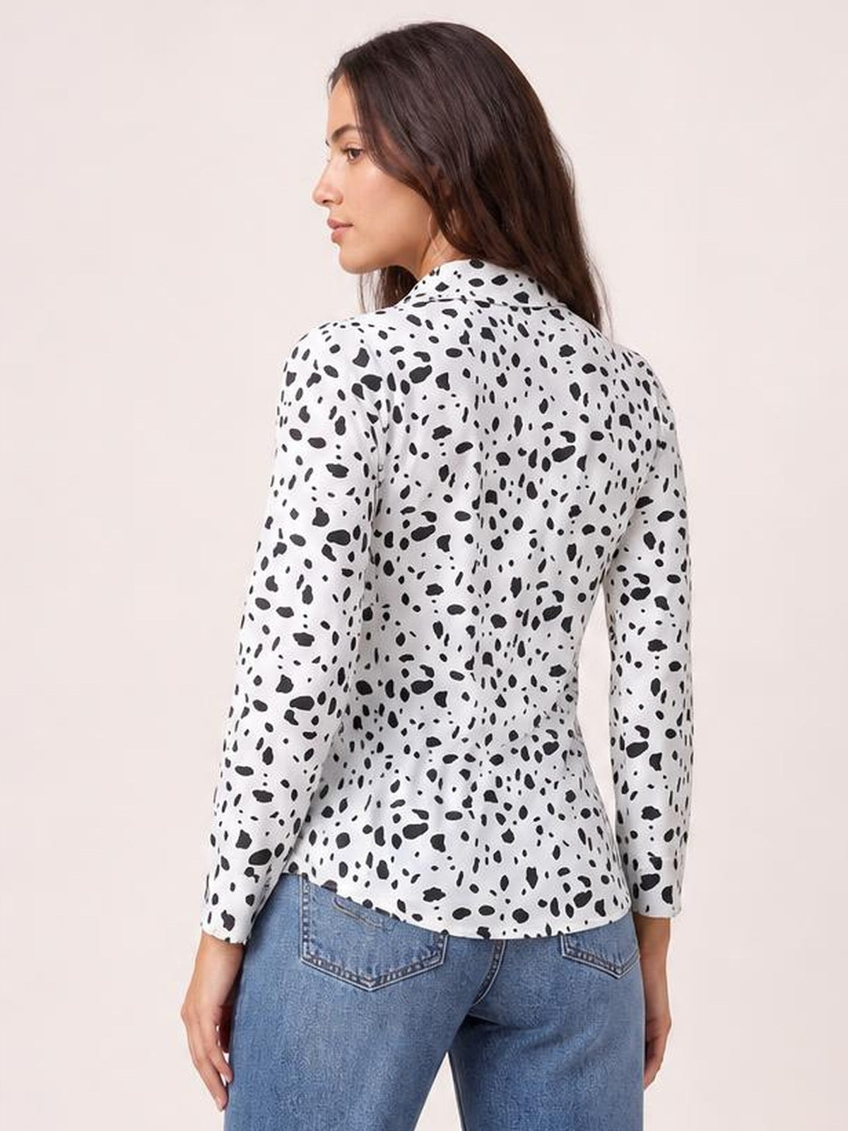 Model shown from the back wears a white and black animal print button-up shirt with a collared neckline, long sleeves, regular fit, and curved hem.