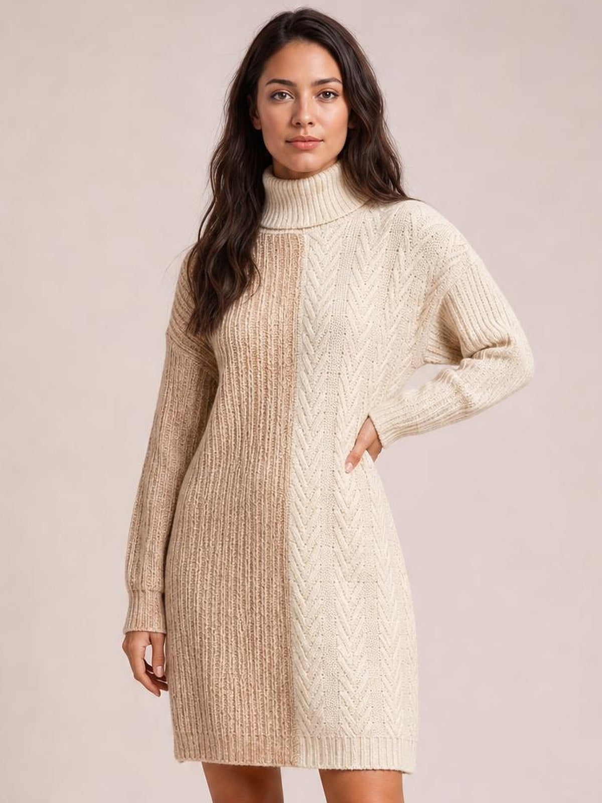 Model poses in a taupe and cream color block turtleneck sweater dress with long sleeves, ribbed knit texture, and a relaxed straight silhouette.