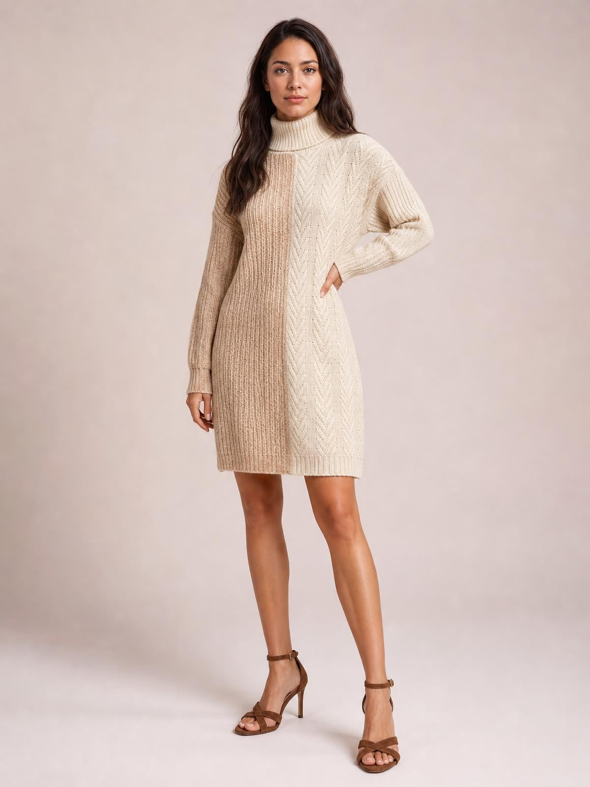Model poses in a cream and beige color block turtleneck sweater dress with ribbed knit texture, long sleeves, a straight knee-length silhouette, and subtle stretch.