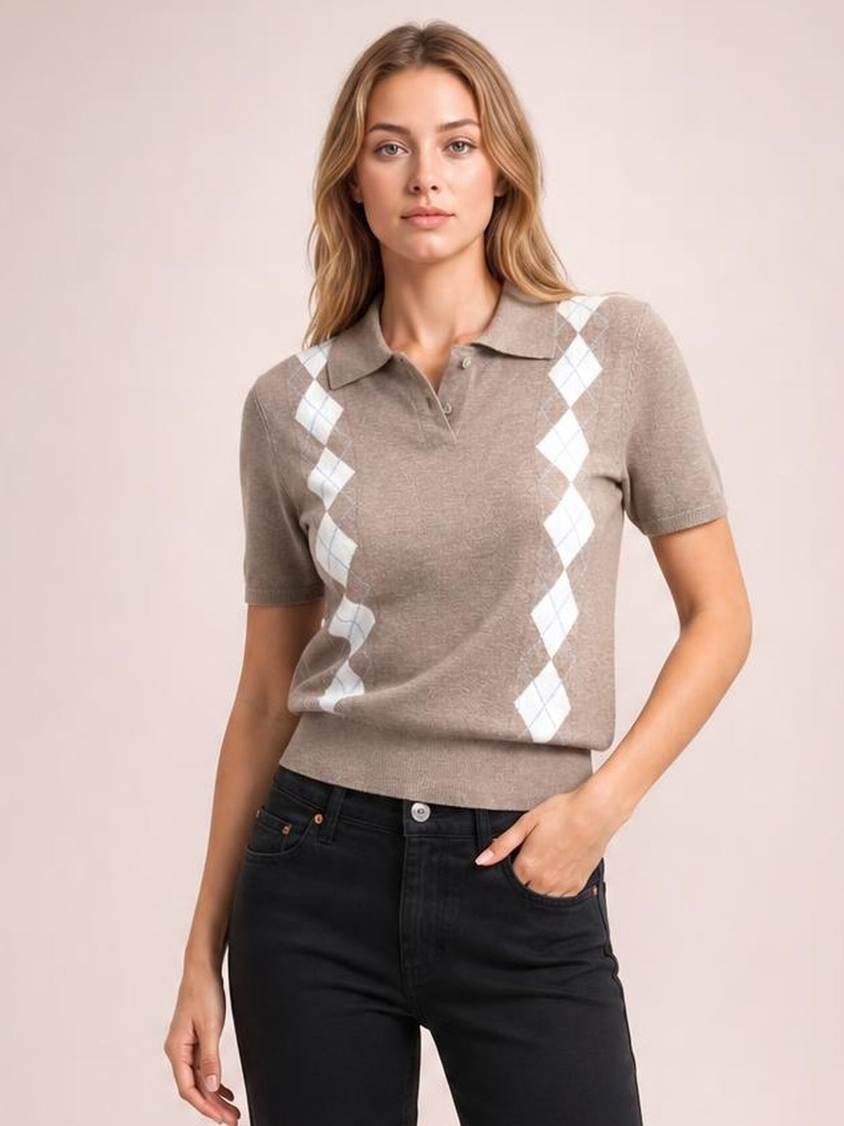 Model poses in a taupe argyle patterned short sleeve sweater with a collared neckline, button placket, fitted silhouette, and ribbed hem.