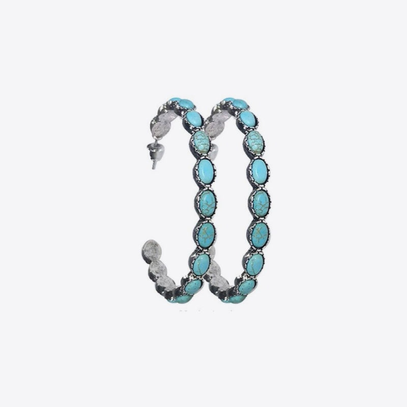 A pair of alloy hoop earrings features elongated curved silhouettes with alternating artificial turquoise and gray oval stones linked in a statement design.
