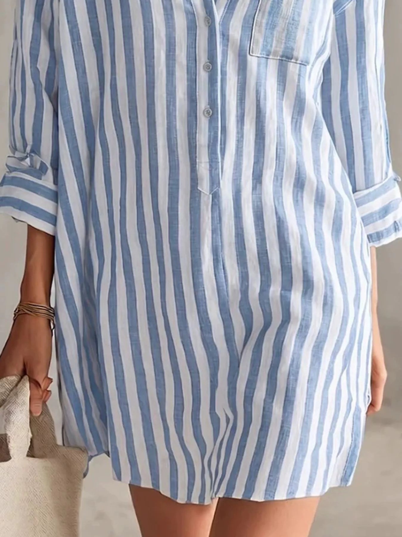 Plus-size blue and white striped shirt mini dress with button front, chest pocket, and rolled sleeves