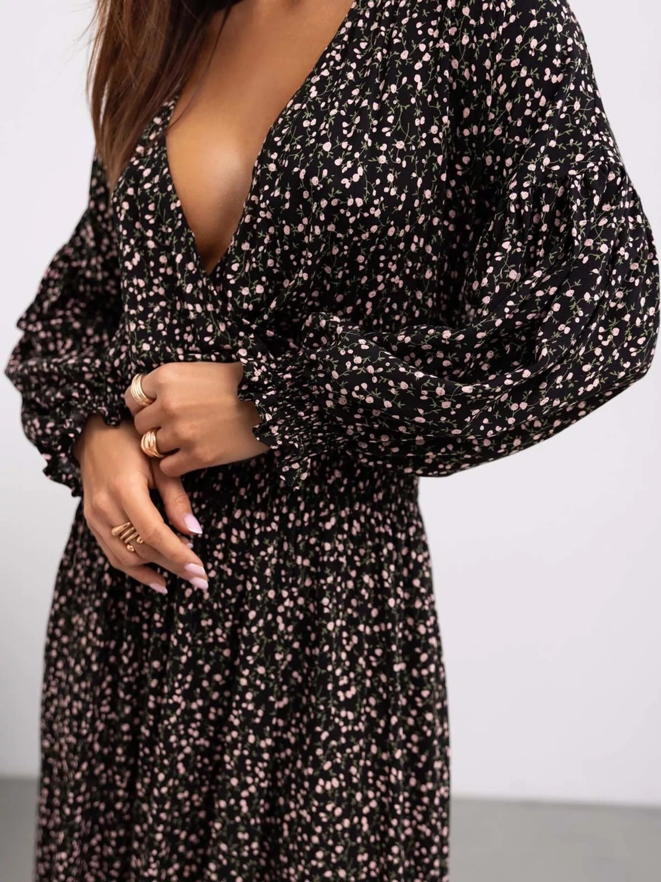 Bohemian floral printed maxi dress with plunging neckline, ruched waist, tiered skirt, and long flowy sleeves