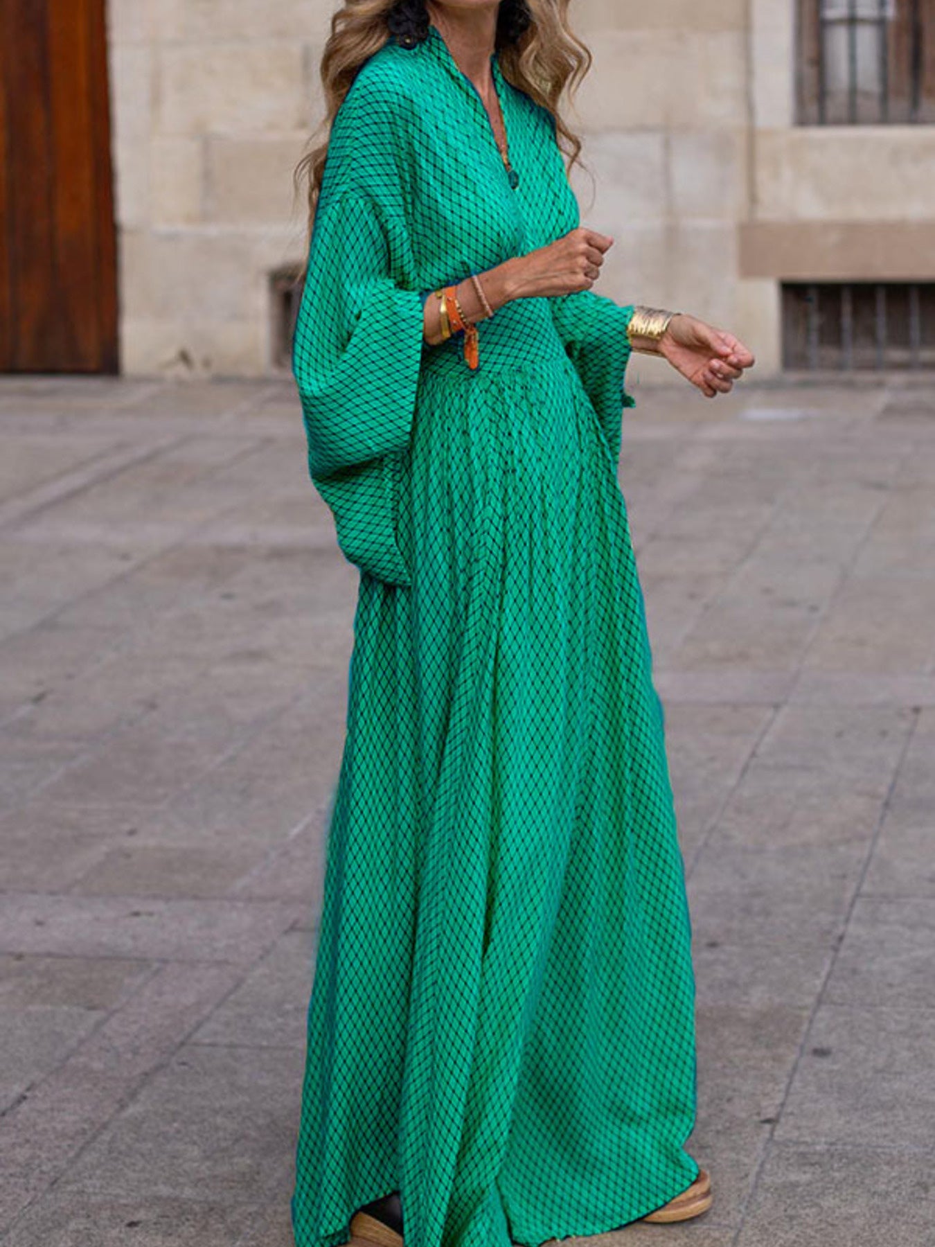 Flowy geometric maxi dress with V-neck and long sleeves in green, black, gray, red, and yellow