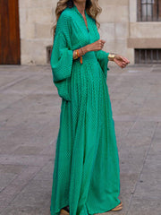 Flowy geometric maxi dress with V-neck and long sleeves in green, black, gray, red, and yellow