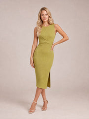 Model poses with one hand on her hip in a chartreuse sleeveless midi dress featuring a draped crossover front, body-skimming silhouette, and side slit.