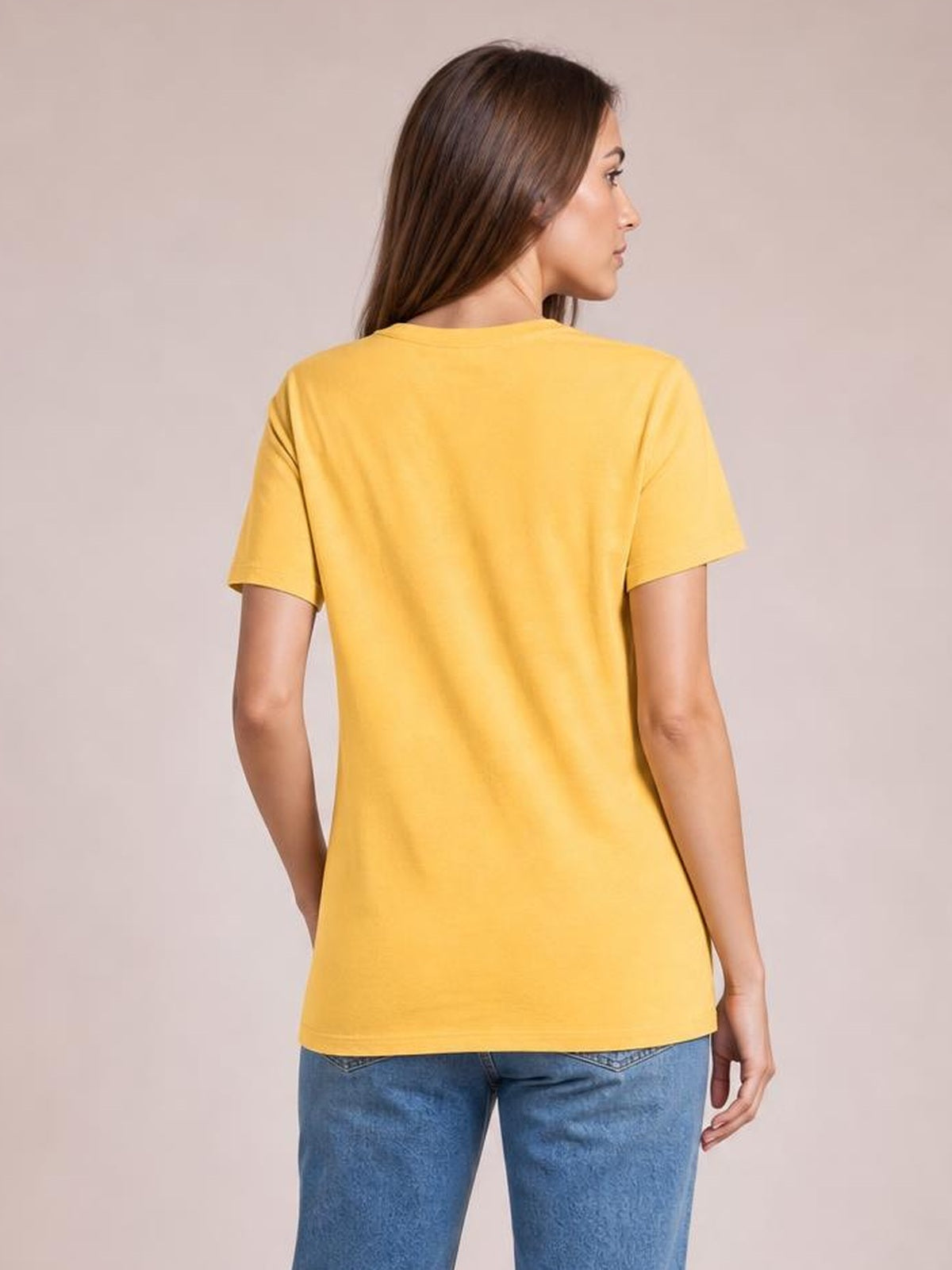 A model turned away wears a yellow bamboo-blend T-shirt with short sleeves, a relaxed straight silhouette, and a gently curved hem.