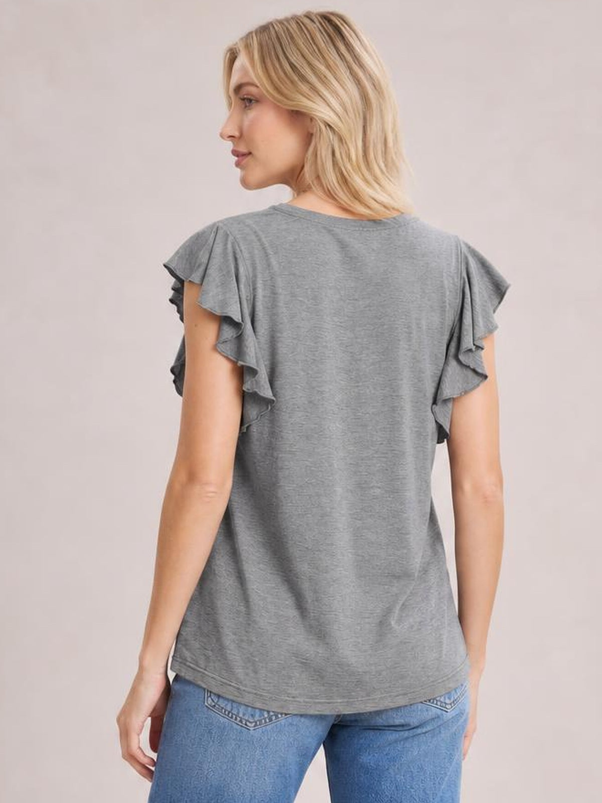 Model shown from behind wearing a gray bamboo T-shirt with layered ruffled short sleeves, a relaxed straight silhouette, and a curved hem.