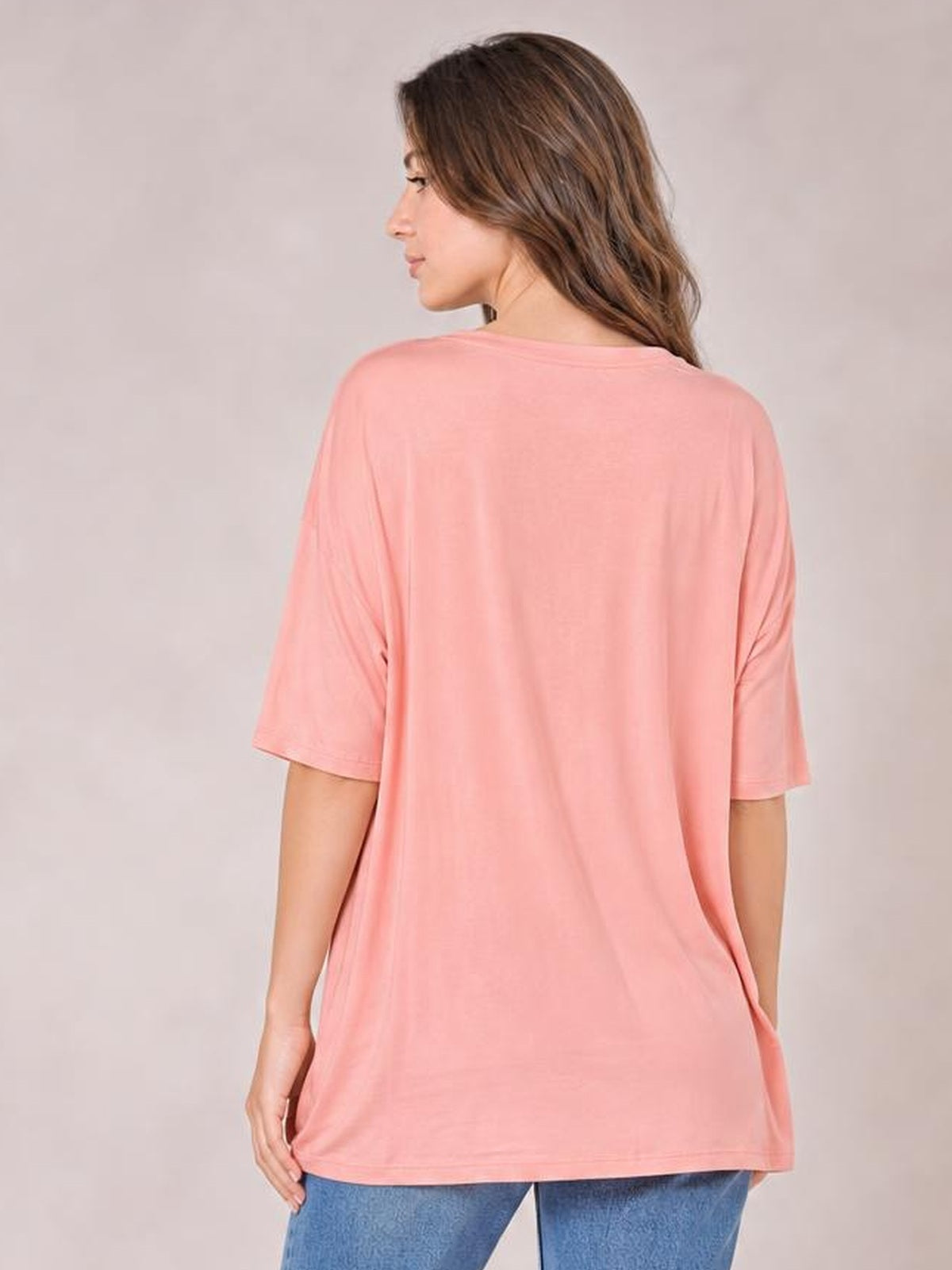 Model shown from behind in a pink Bamboo V-Neck Drop Shoulder T-Shirt with a relaxed oversized silhouette, short sleeves, and a straight hem.