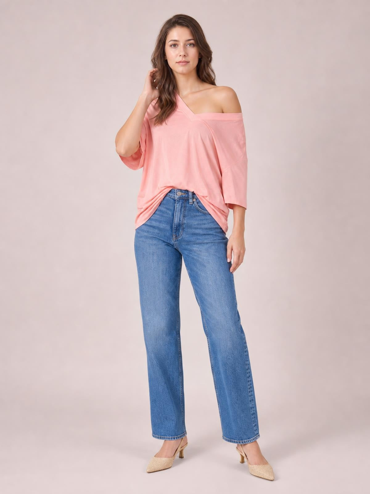 Model poses in a soft pink Bamboo V-Neck Drop Shoulder T-Shirt with a relaxed silhouette, stretchy fabric, and wide three-quarter sleeves.