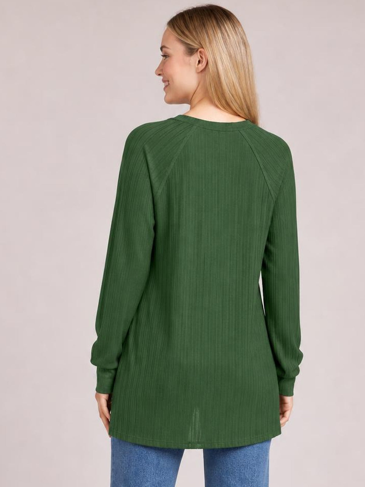 Model shown from behind wearing a green ribbed round-neck T-shirt with long sleeves, raglan seams, a relaxed silhouette, and blue jeans.