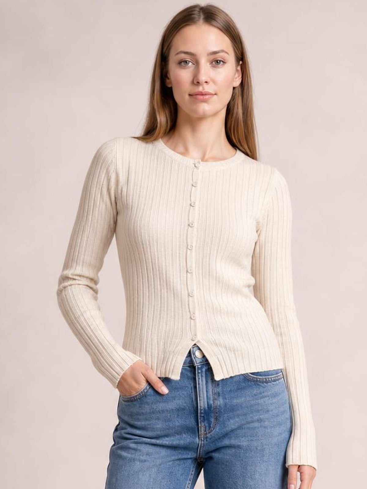 Model wearing a cream textured button-up round-neck long-sleeve top with a fitted silhouette, vertical ribbing, and one hand resting in her jeans pocket.