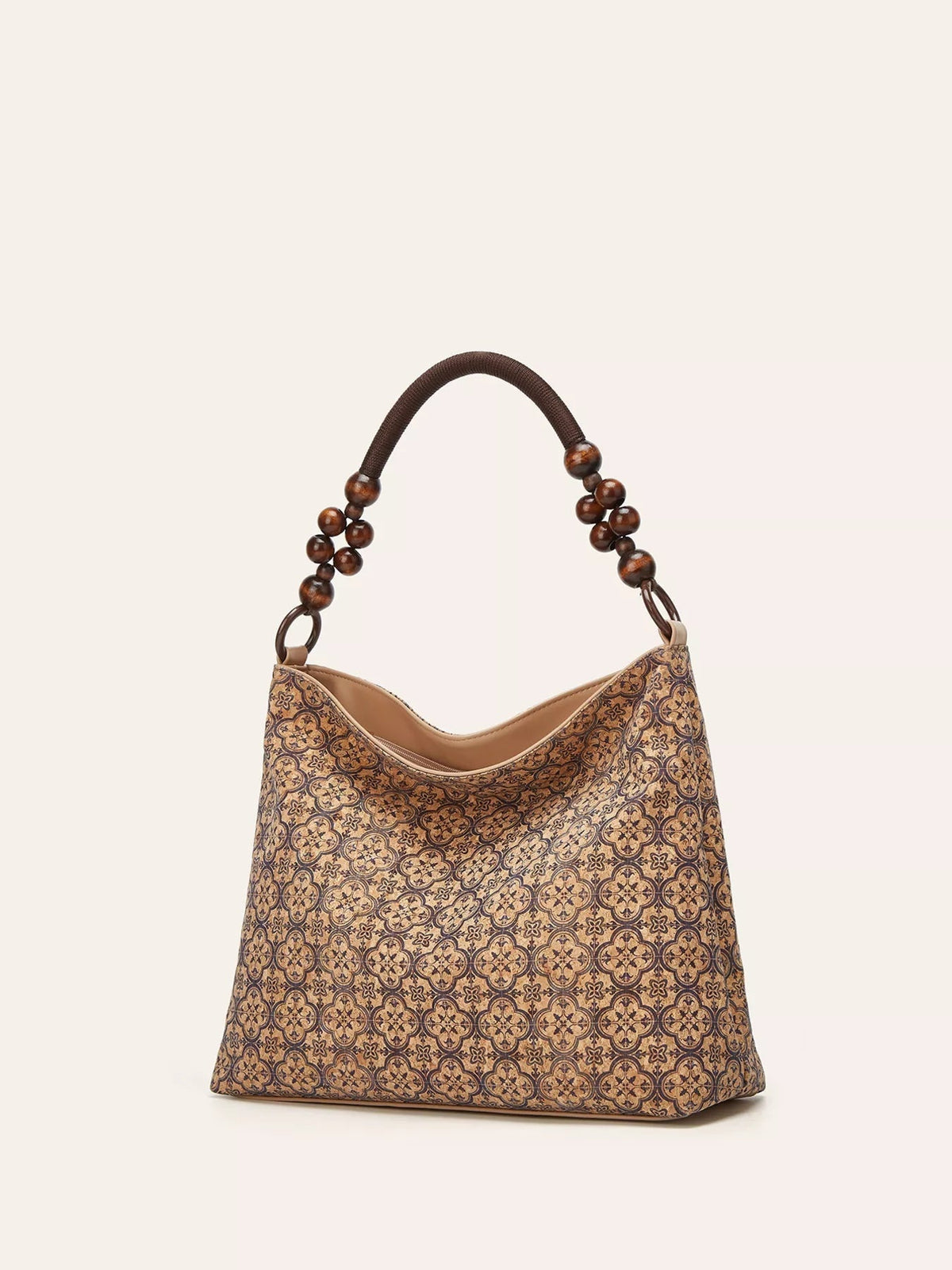 A medium bohemian hobo handbag in tan and brown PU leather features a geometric pattern, curved zippered opening, and a beaded rounded handle.