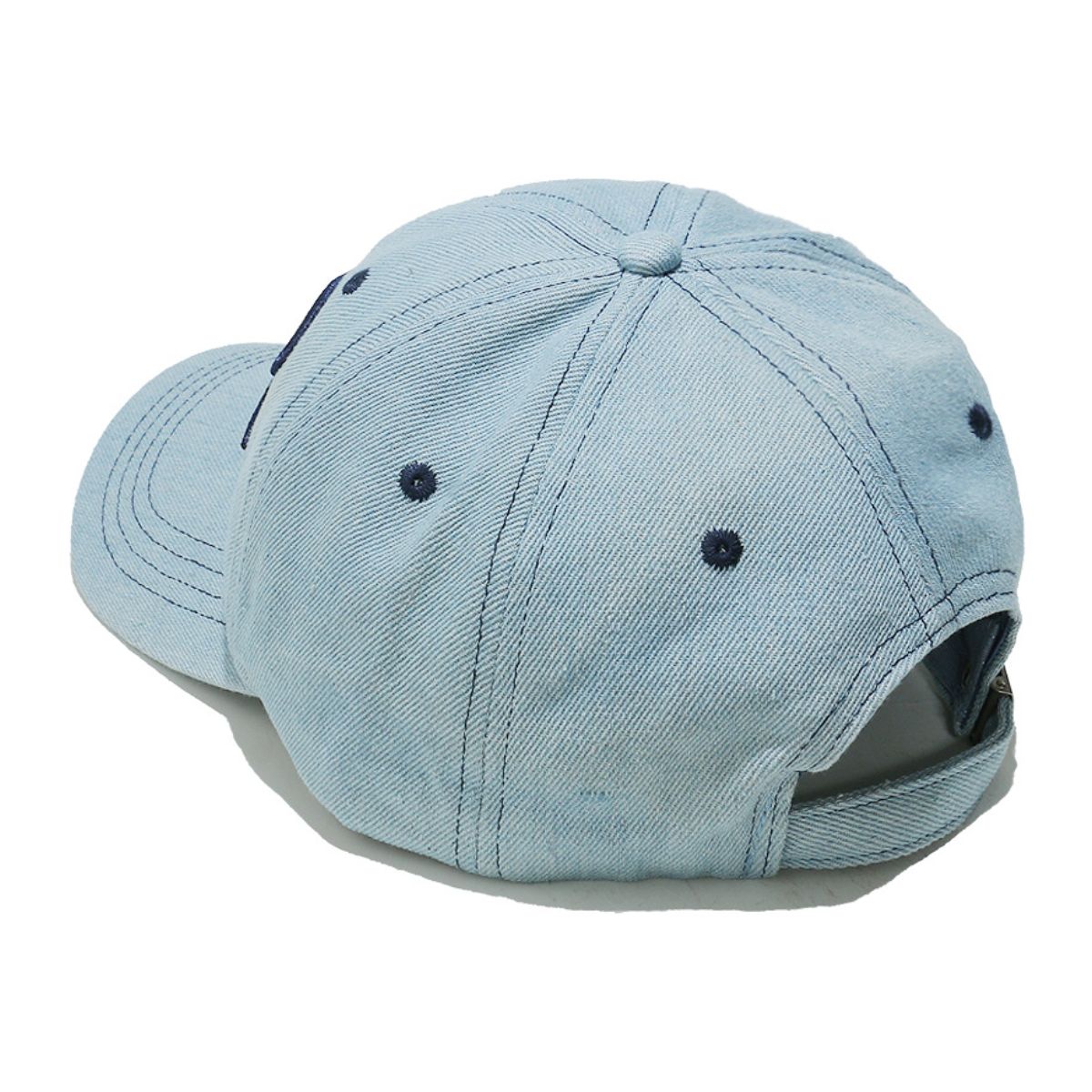 Light blue denim cotton baseball cap with a six-panel crown, curved brim, contrast topstitching, ventilation eyelets, and an adjustable back strap.