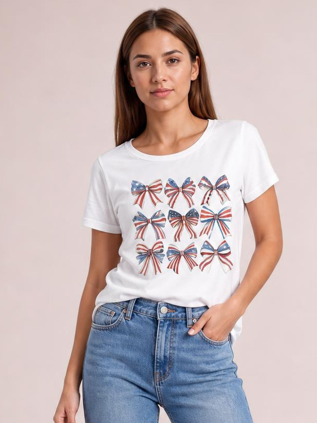 Model wearing a white round neck short sleeve T-shirt with a colorful bow graphic arranged across the front and a relaxed silhouette.