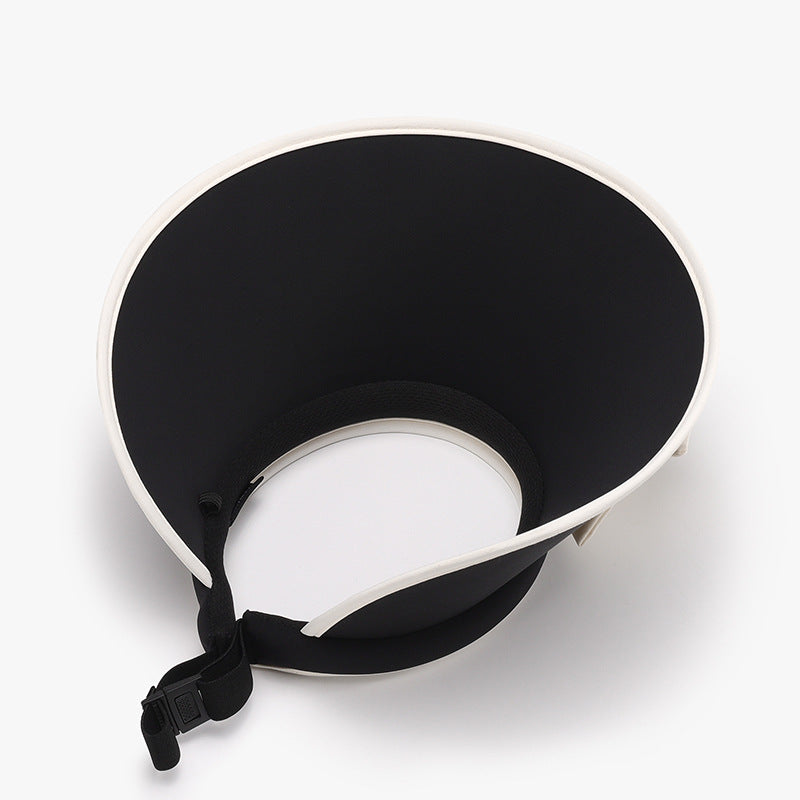 Black ice silk sun hat with a softly structured visor silhouette, wide curved brim, contrasting white trim, and an adjustable under-chin cord.