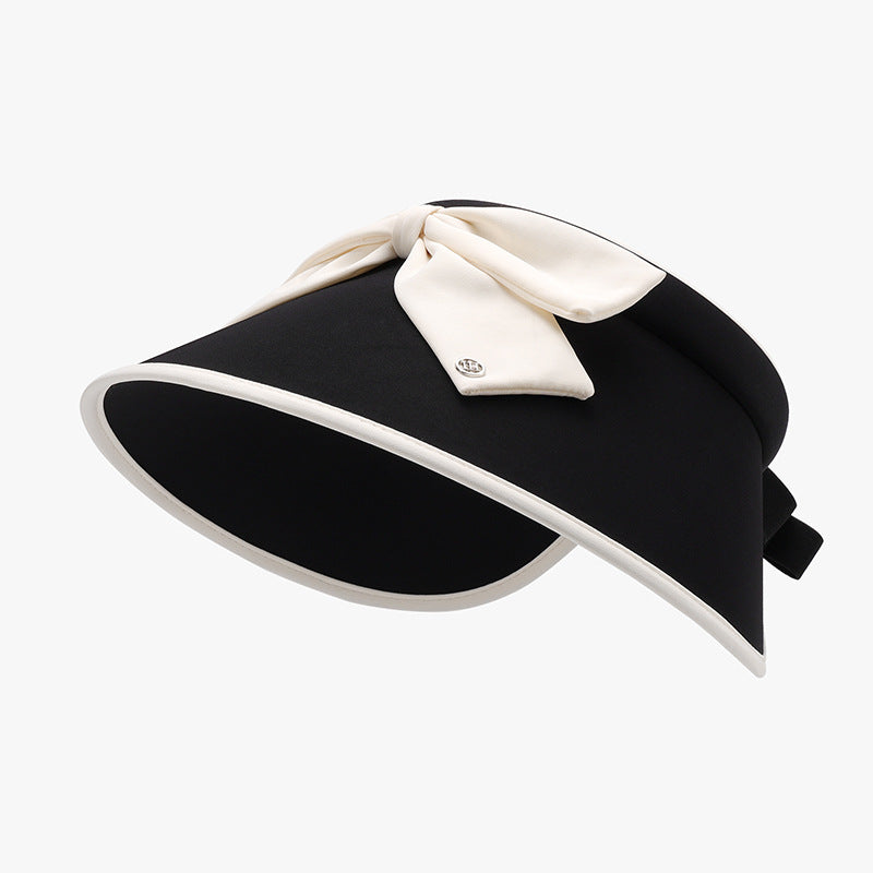 Black ice silk sun hat with a graceful visor-inspired silhouette, wide curved brim, contrasting cream trim, and a feminine bow accent on the crown.