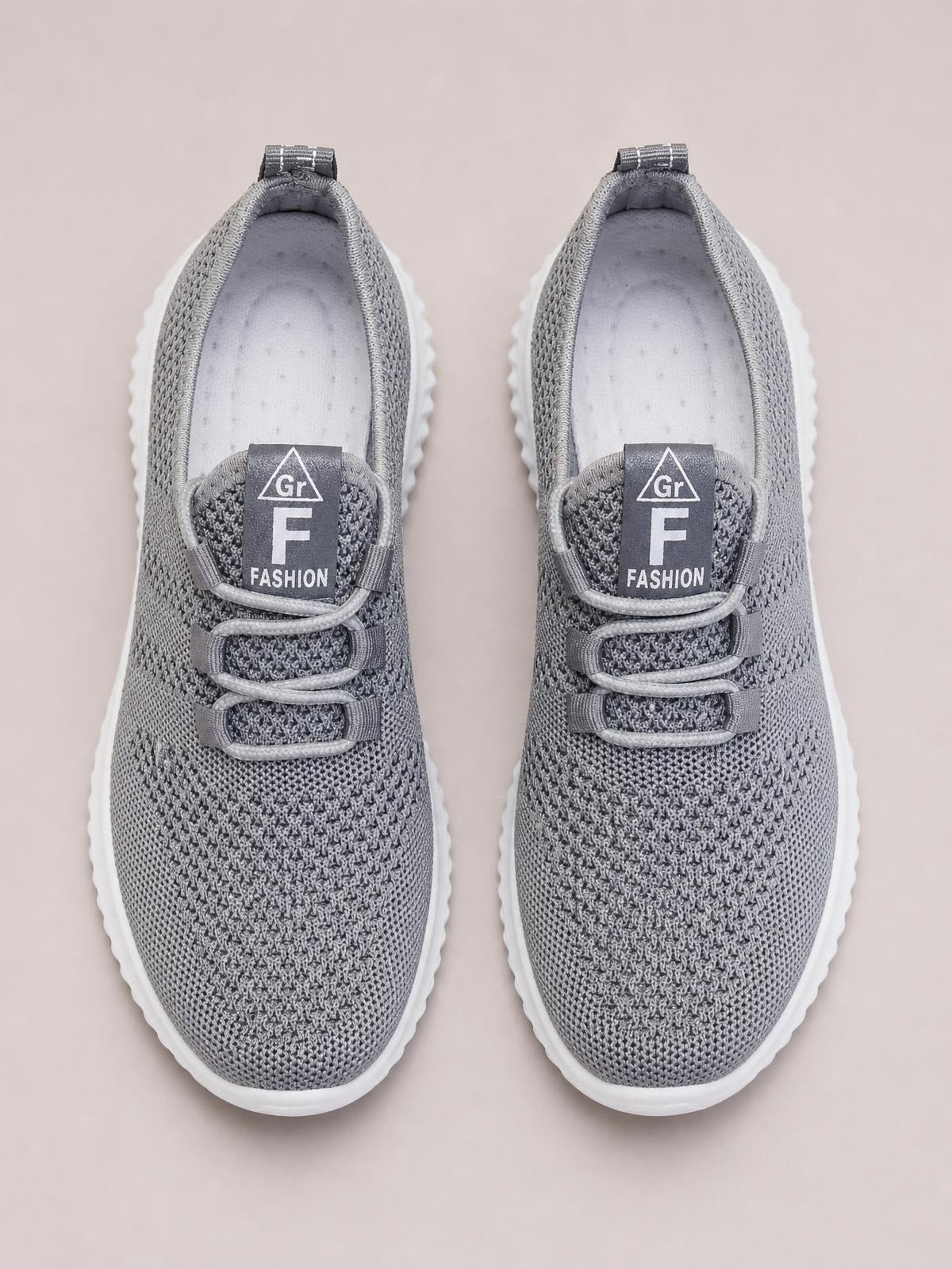 Gray breathable mesh lace-up athletic shoes with a streamlined silhouette, textured uppers, padded collars, and white rubber flat soles.