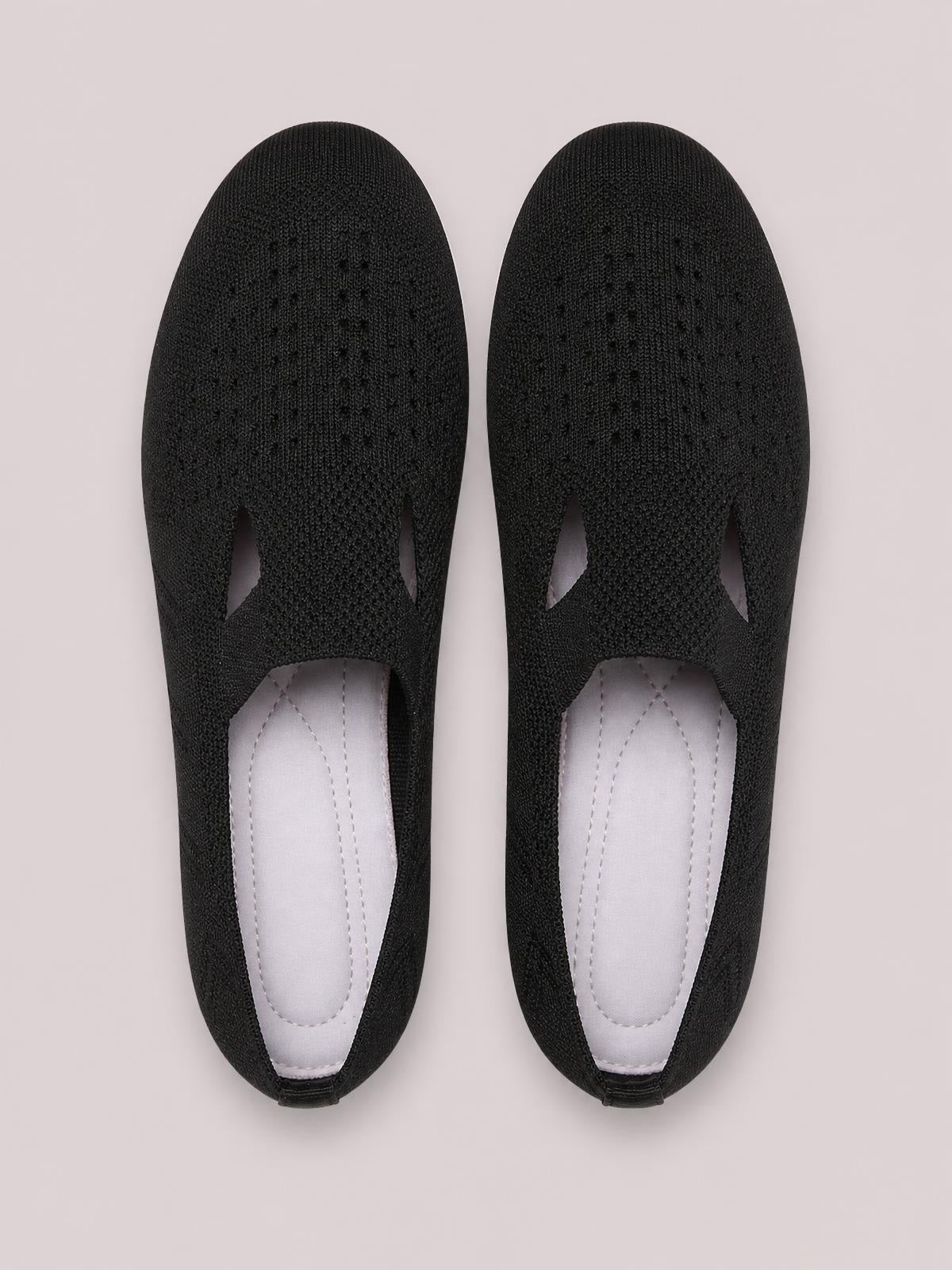 Black breathable mesh round-toe flat slip-ons with open side cutouts, cushioned insoles, and flexible rubber soles.