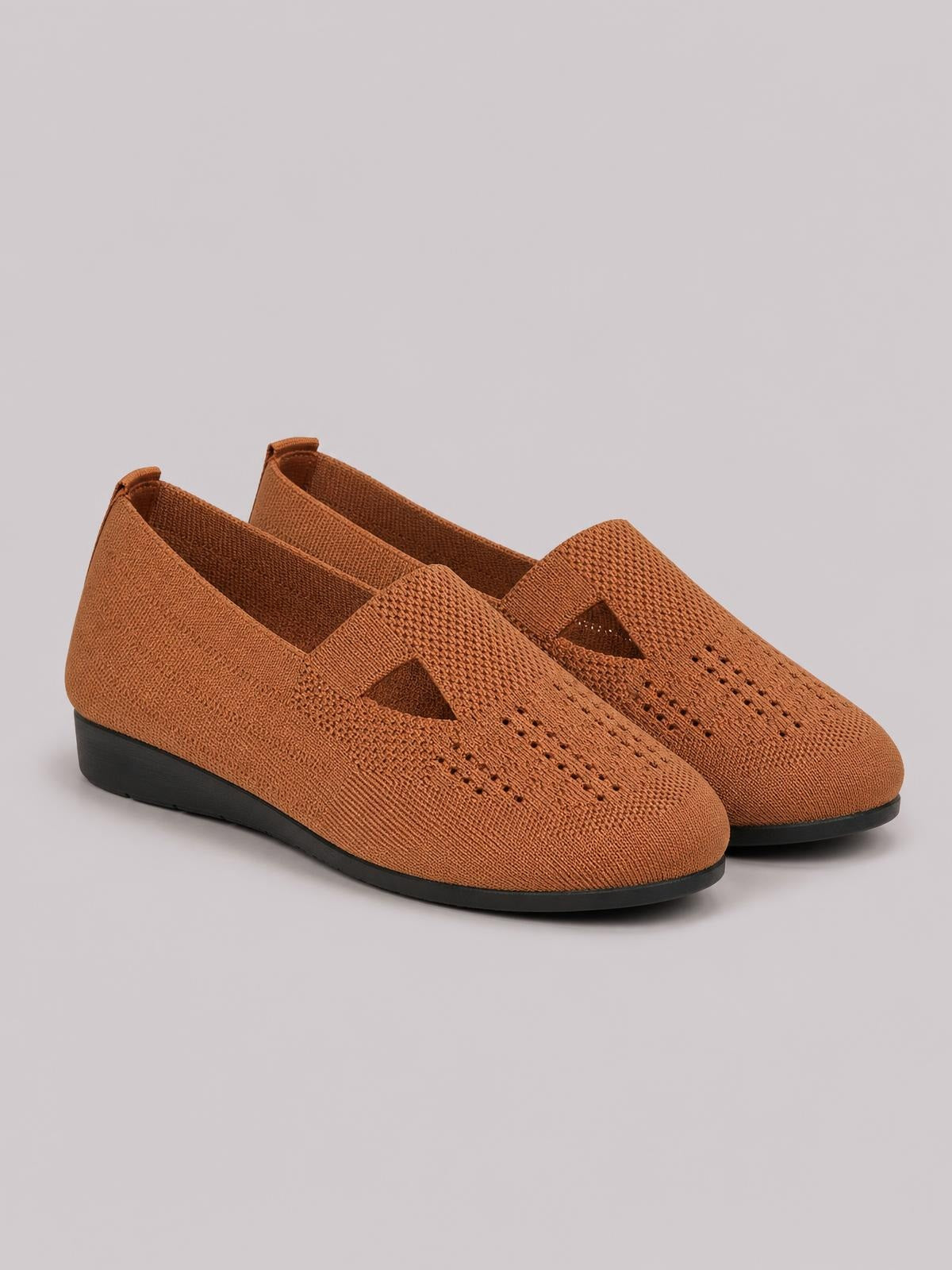Brown breathable mesh round-toe flat slip-ons feature perforated uppers, overlapping instep straps with cutout details, and black rubber soles.