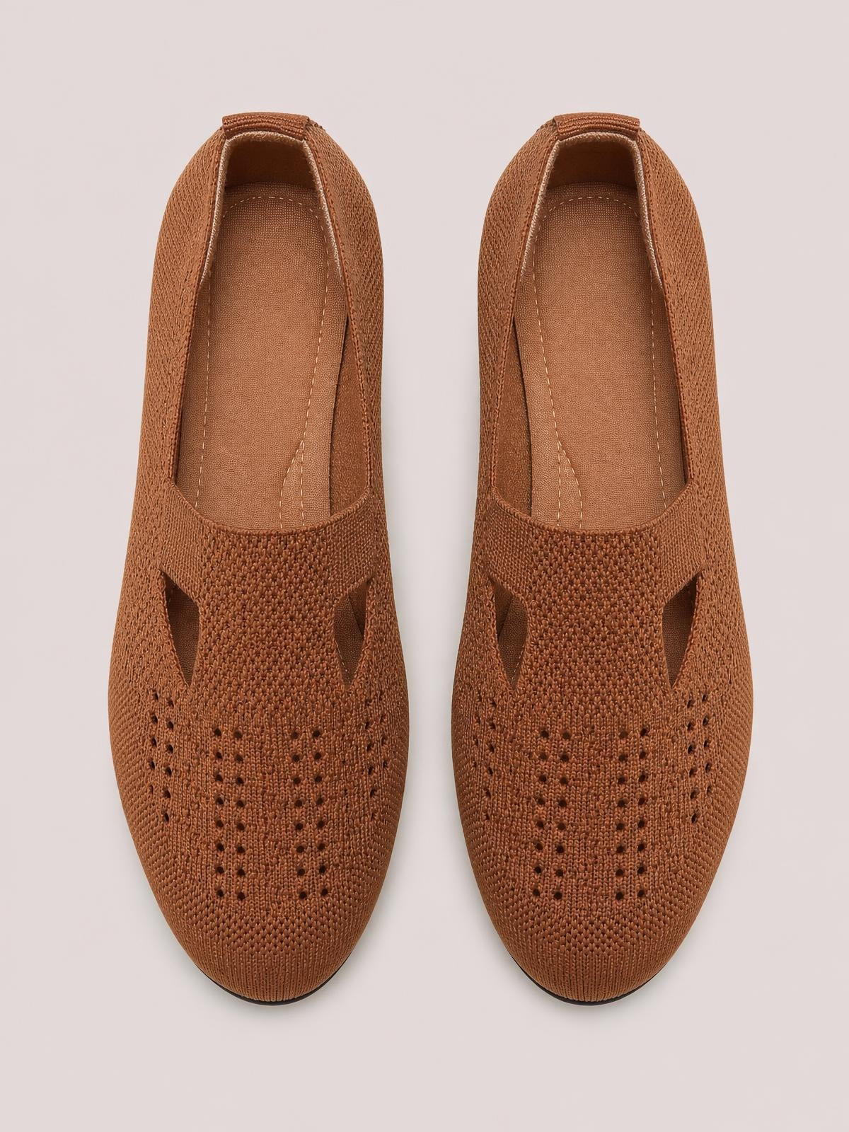 Brown breathable mesh round-toe flat slip-ons with woven perforations, open side panels, low-profile rubber soles, and cushioned stitched insoles.