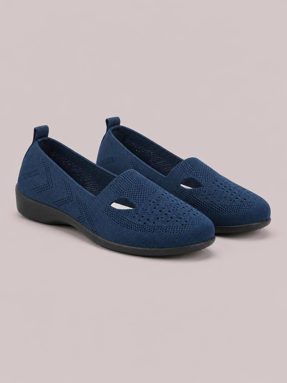 Navy breathable mesh round-toe flat slip-ons feature a perforated knit upper, easy pull tabs, and durable black rubber soles.