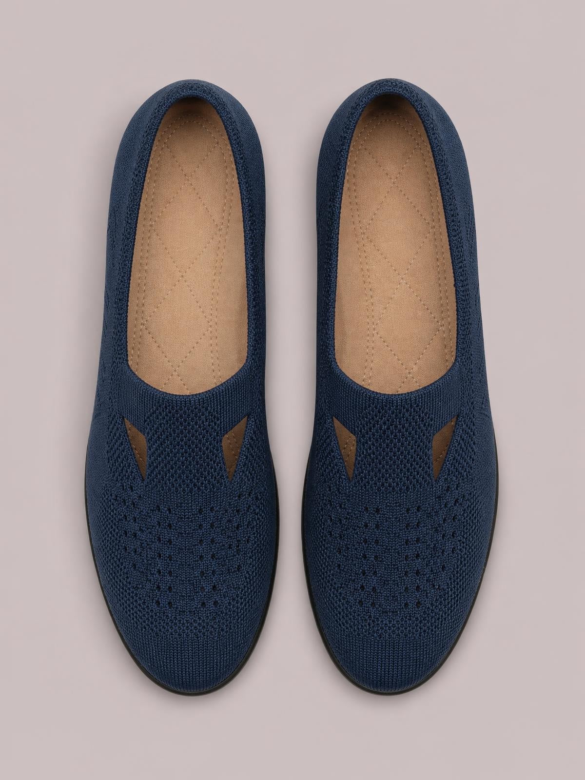 Navy mesh round-toe flat slip-ons with breathable knit uppers, cushioned insoles, open side accents, and dark rubber soles.