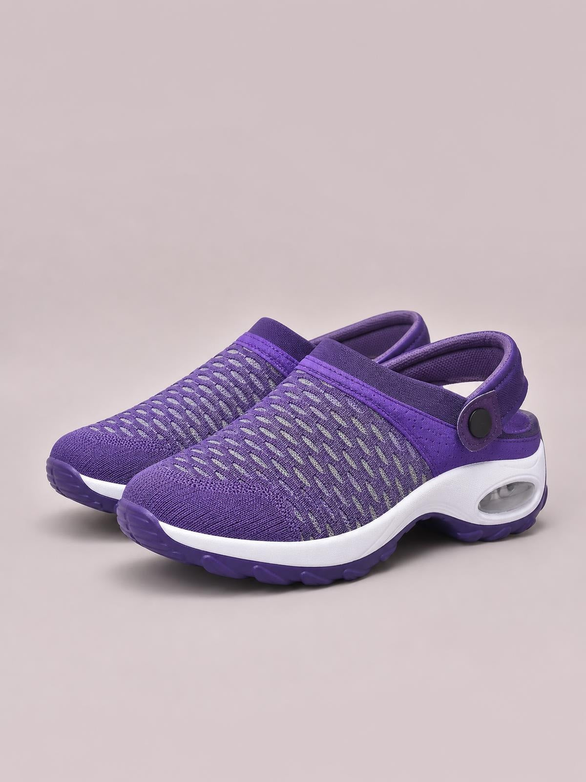 Purple breathable mesh round-toe sneakers feature a textured upper, cushioned white midsole, purple rubber outsole, and a rear strap with a round side button.